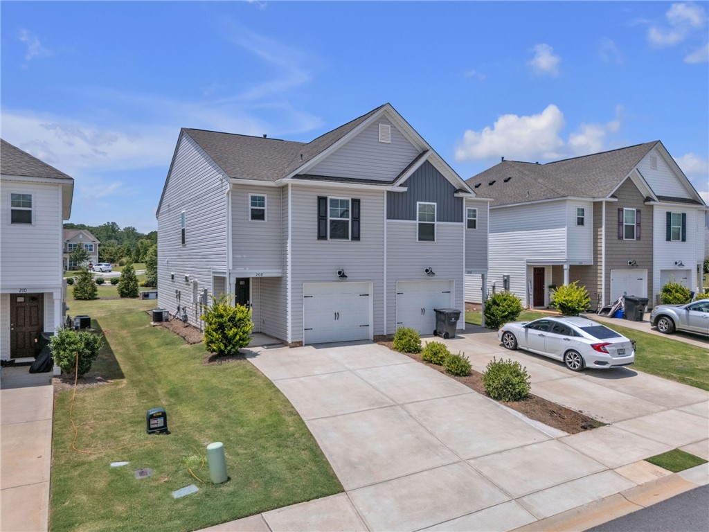208 Samuel Street Pendleton, SC 29670 - Photo 2 of 32 Attached garages and concrete driveways welcome you to these charming suburban townhomes.