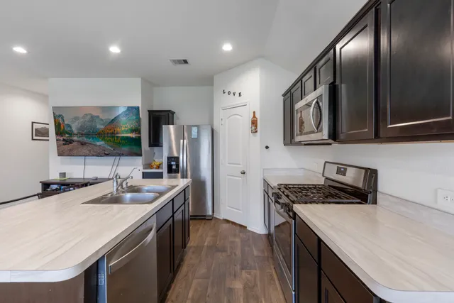 a kitchen with a sink and a refrigerator