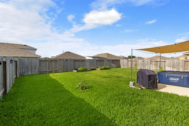 a view of a house with a backyard