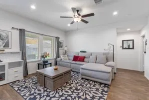 a living room with furniture and wooden floor