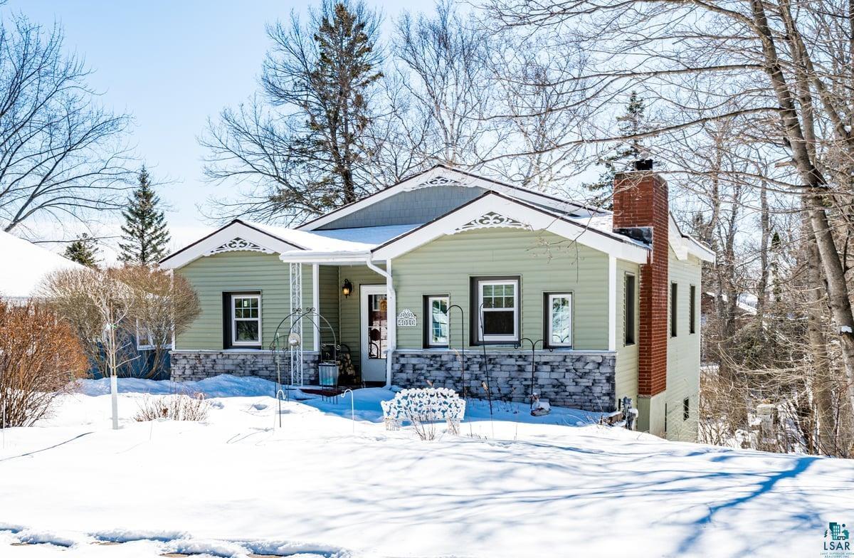 4010 Robinson Street Duluth, MN 55804 - Photo 1 of 35 View of front facade with a porch, stone siding, and a chimney
