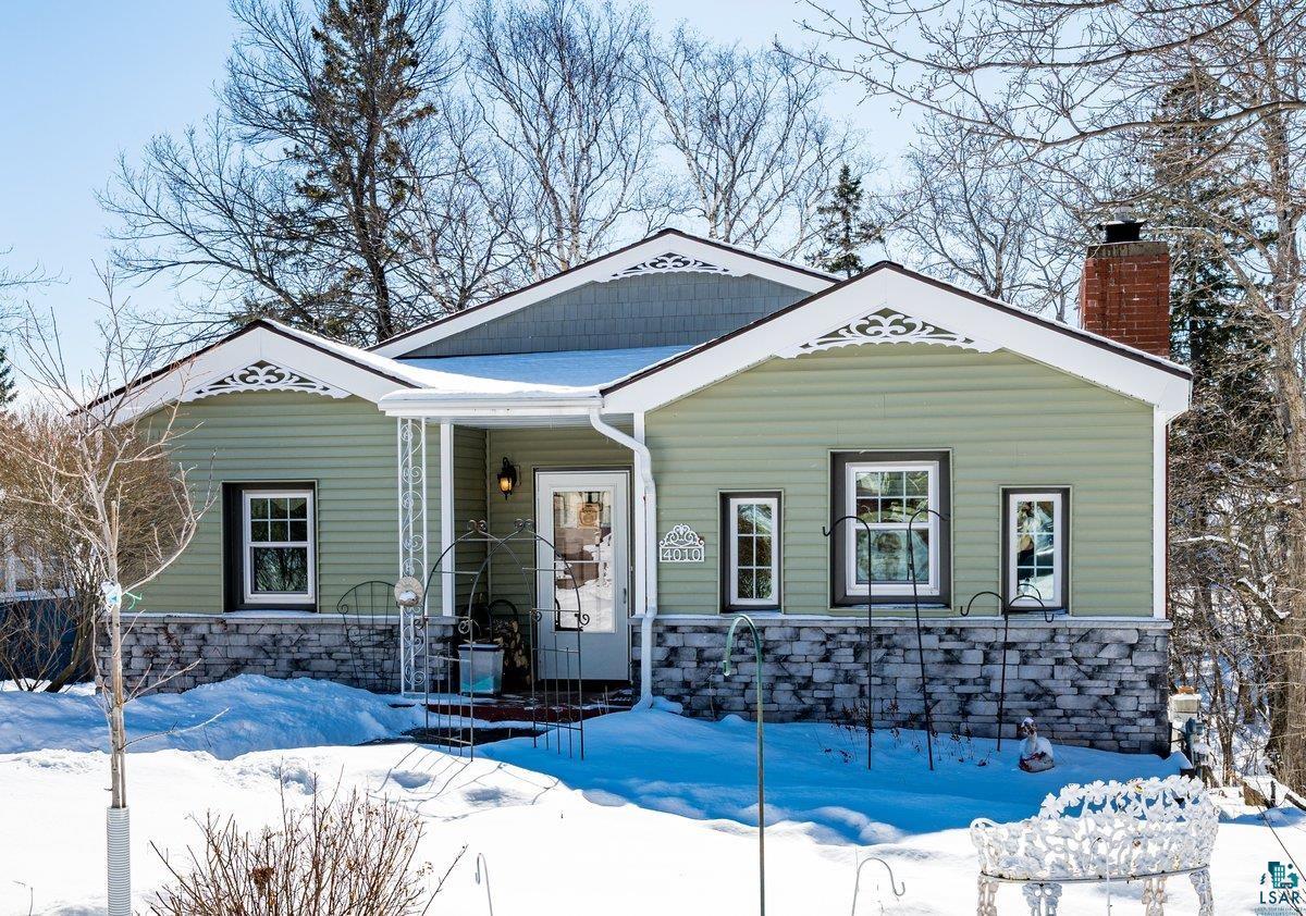 4010 Robinson Street Duluth, MN 55804 - Photo 2 of 35 View of front of house featuring covered porch, stone siding, and a chimney