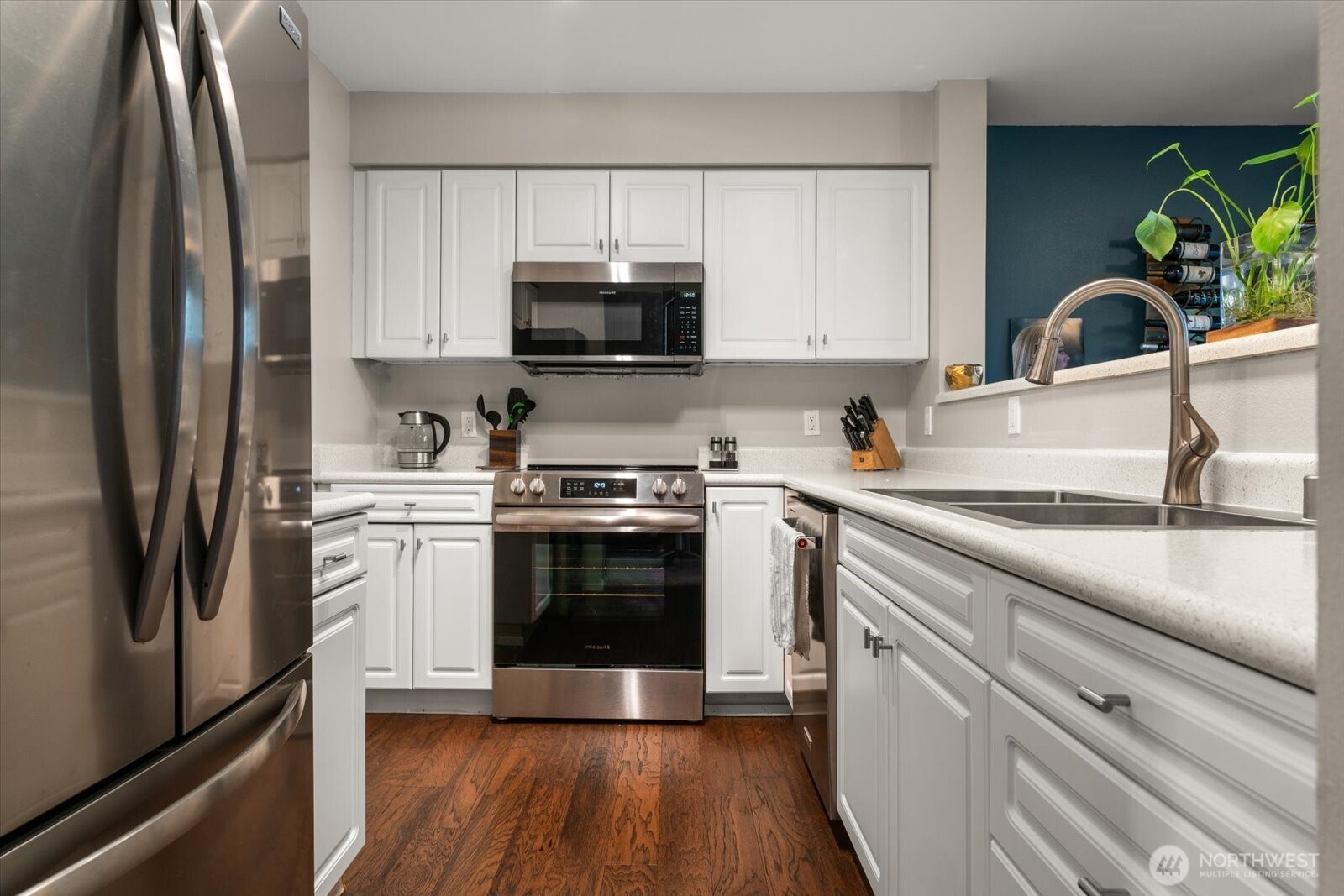 15150 140th Way Southeast, Unit T104 Renton, WA 98058 - Photo 16 of 40 a kitchen with stainless steel appliances a sink dishwasher a refrigerator and a stove top oven