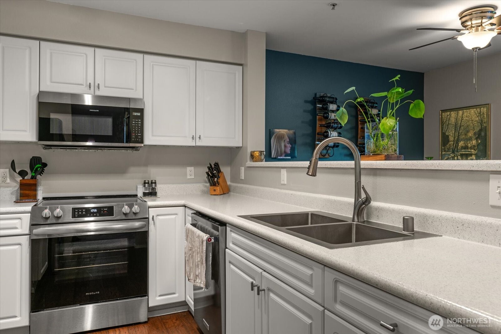 15150 140th Way Southeast, Unit T104 Renton, WA 98058 - Photo 17 of 40 a kitchen with granite countertop a sink stainless steel appliances and cabinets