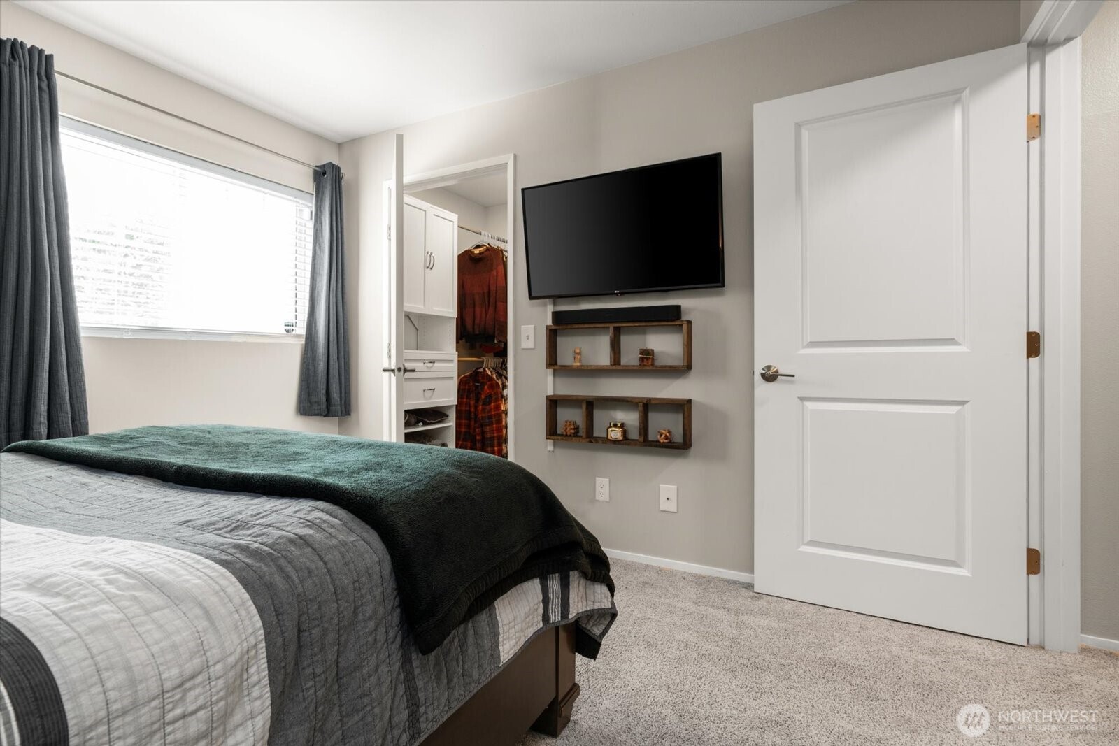 15150 140th Way Southeast, Unit T104 Renton, WA 98058 - Photo 22 of 40 a bedroom with a bed and a flat screen tv