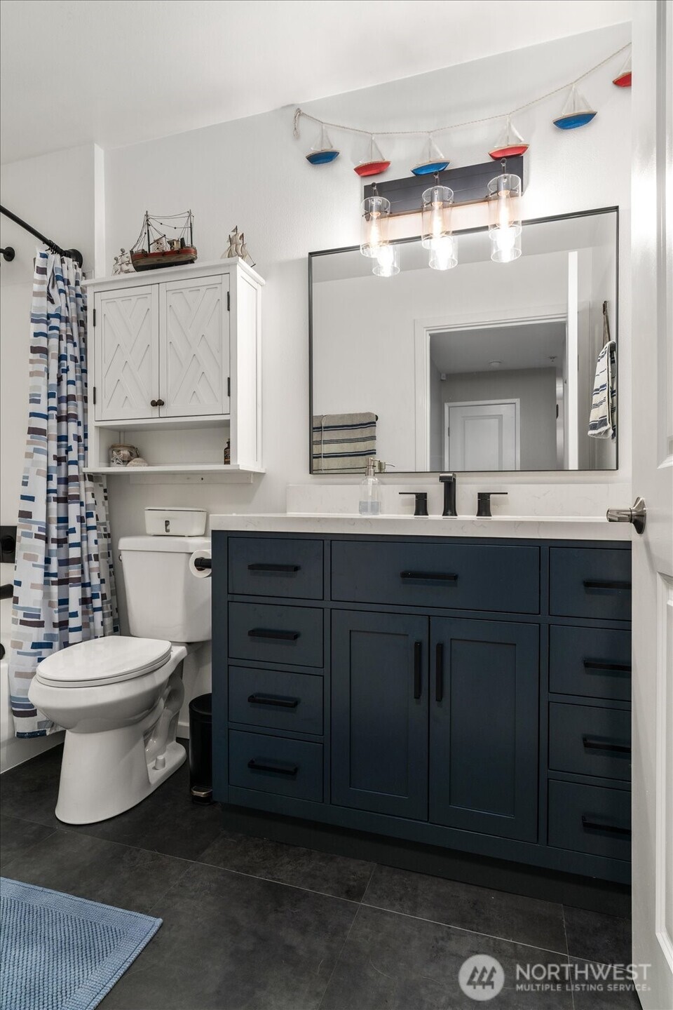15150 140th Way Southeast, Unit T104 Renton, WA 98058 - Photo 24 of 40 a bathroom with a sink a toilet and a mirror