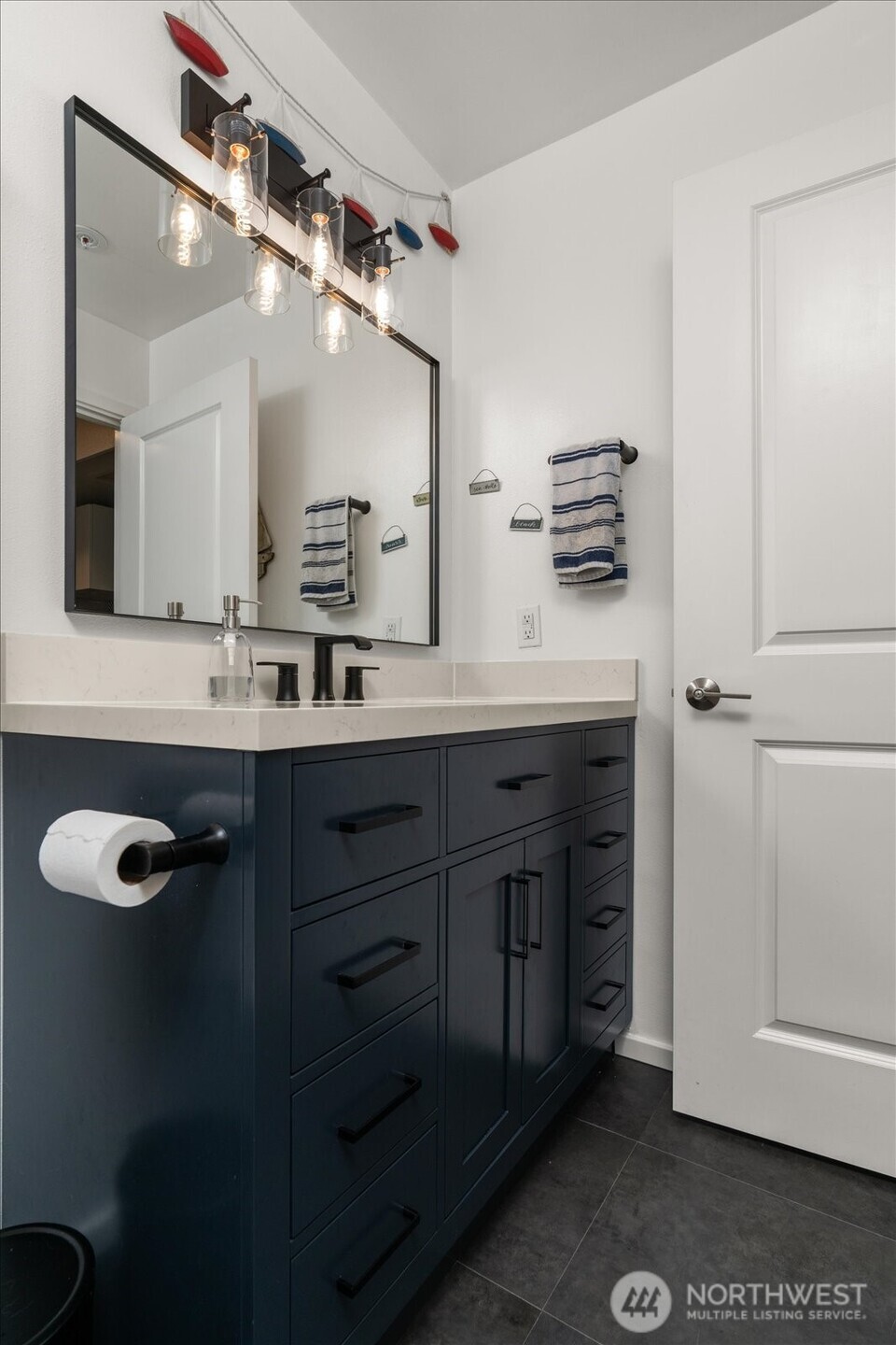 15150 140th Way Southeast, Unit T104 Renton, WA 98058 - Photo 26 of 40 a bathroom with a double vanity sink a mirror and shower