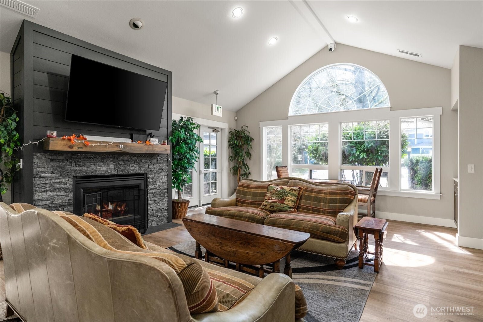 15150 140th Way Southeast, Unit T104 Renton, WA 98058 - Photo 35 of 40 a living room with furniture a flat screen tv and a fireplace