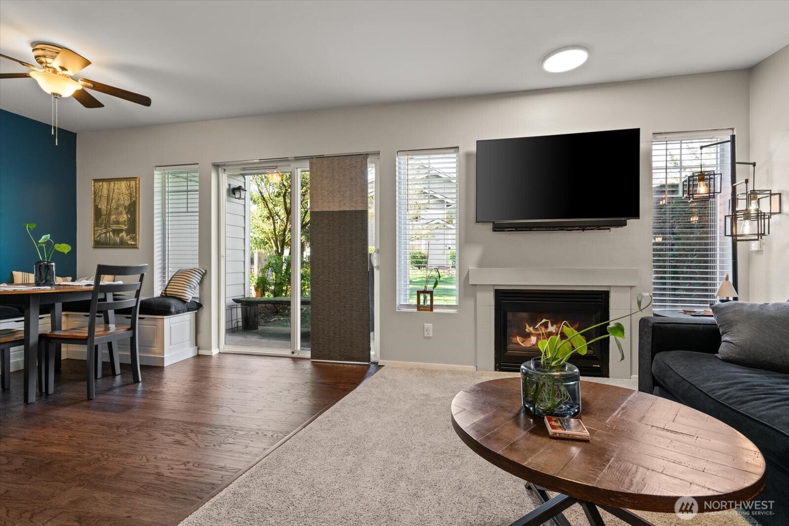 15150 140th Way Southeast, Unit T104 Renton, WA 98058 - Photo 6 of 40 a living room with furniture a fireplace and a flat screen tv