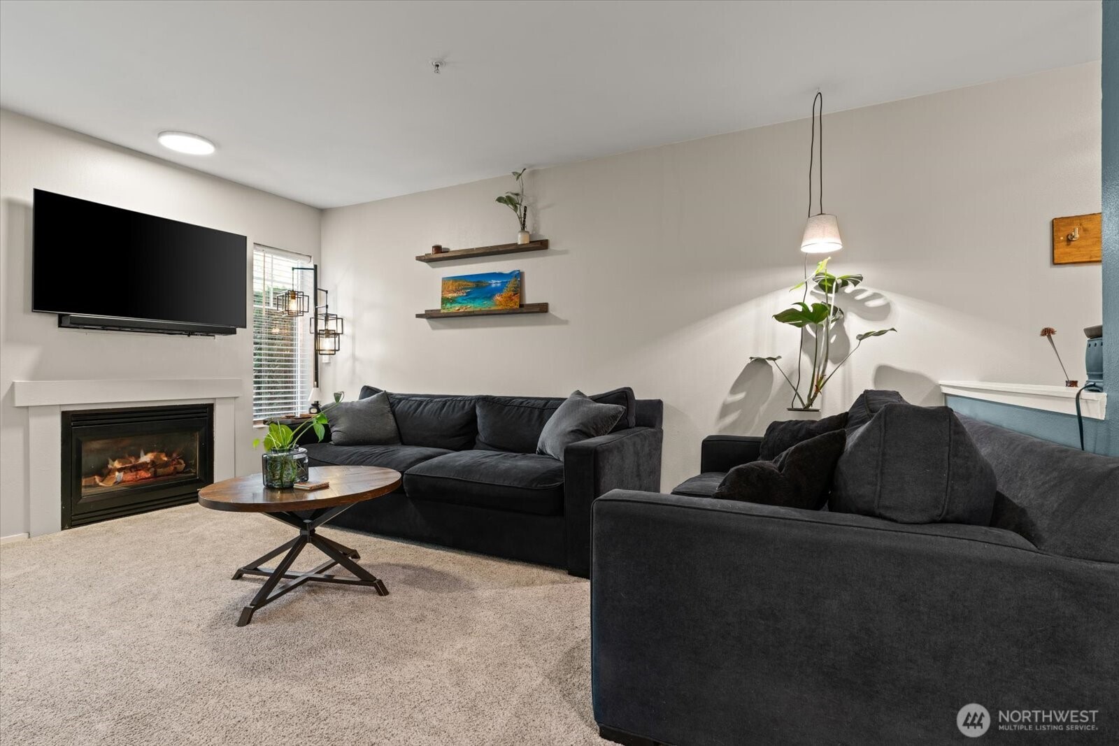 15150 140th Way Southeast, Unit T104 Renton, WA 98058 - Photo 7 of 40 a living room with furniture a fireplace and a flat screen tv