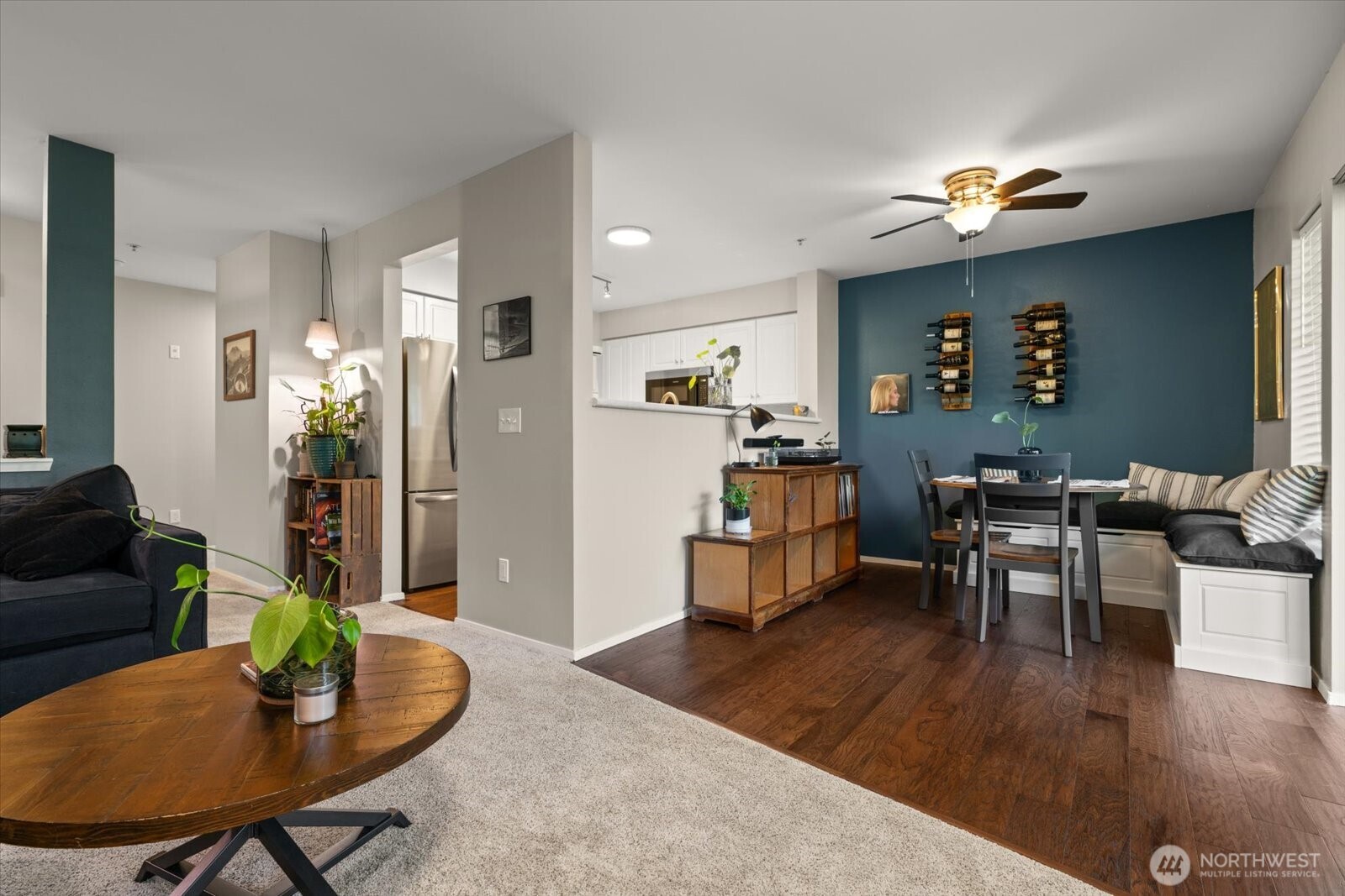 15150 140th Way Southeast, Unit T104 Renton, WA 98058 - Photo 9 of 40 a living room with furniture and a dining table with wooden floor