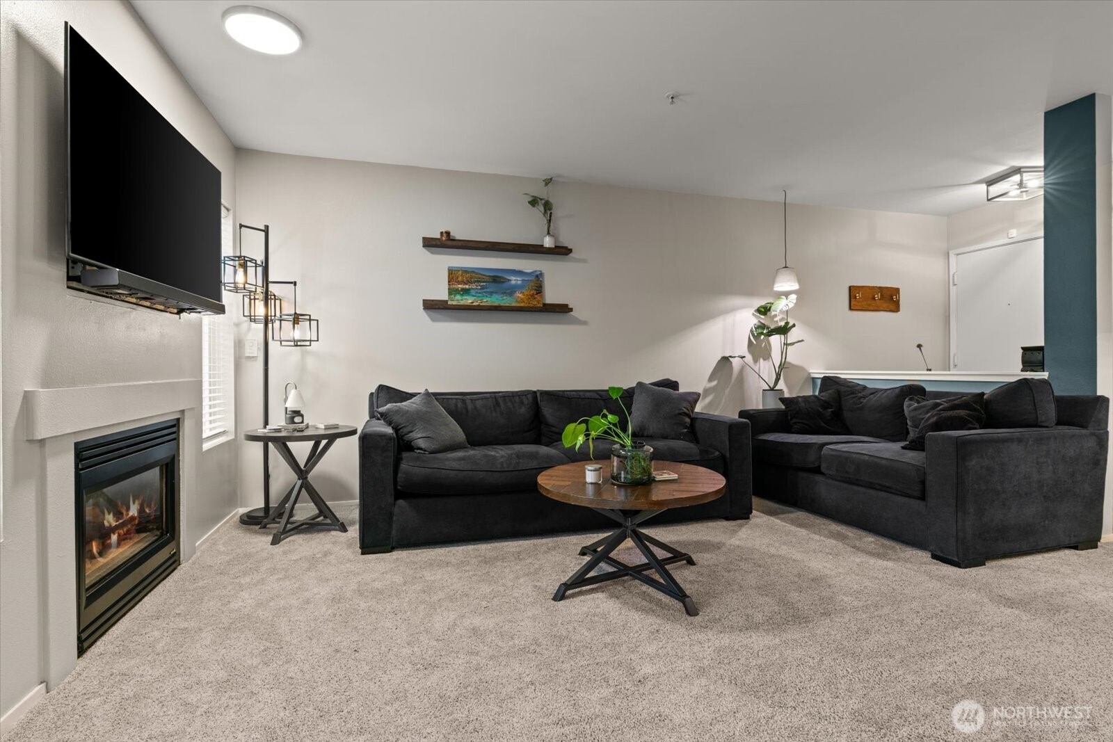 15150 140th Way Southeast, Unit T104 Renton, WA 98058 - Photo 10 of 40 a living room with furniture a flat screen tv and a fireplace