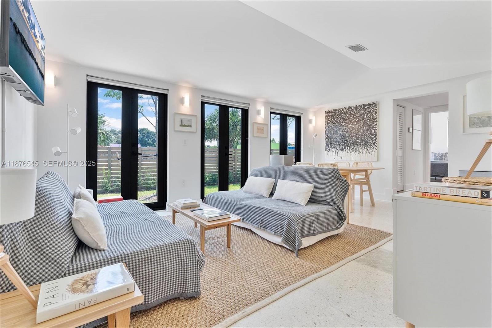 1076 Northwest 55th Street Miami, FL 33127 - Photo 12 of 96 a living room with furniture and large windows