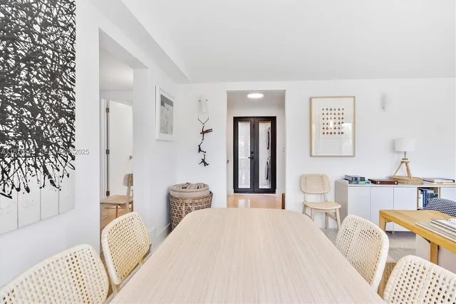 a view of staircase with lots of frames on wall and a window