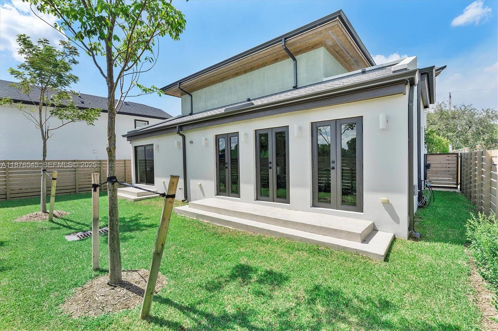 1076 Northwest 55th Street Miami, FL 33127 - Photo 3 of 96 a view of a house with backyard and a tree