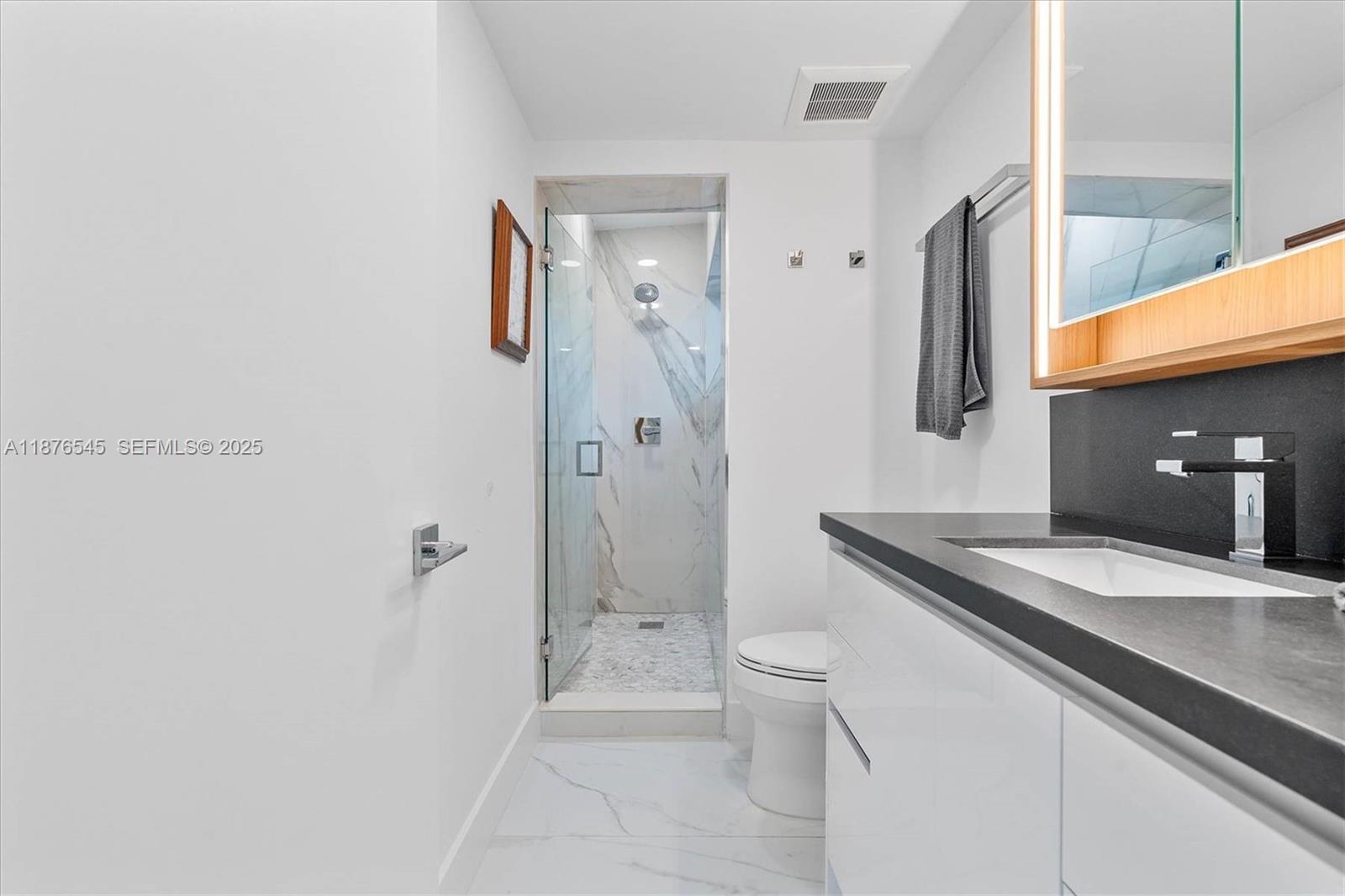 1076 Northwest 55th Street Miami, FL 33127 - Photo 32 of 96 a spacious bathroom with a granite countertop sink a toilet and shower