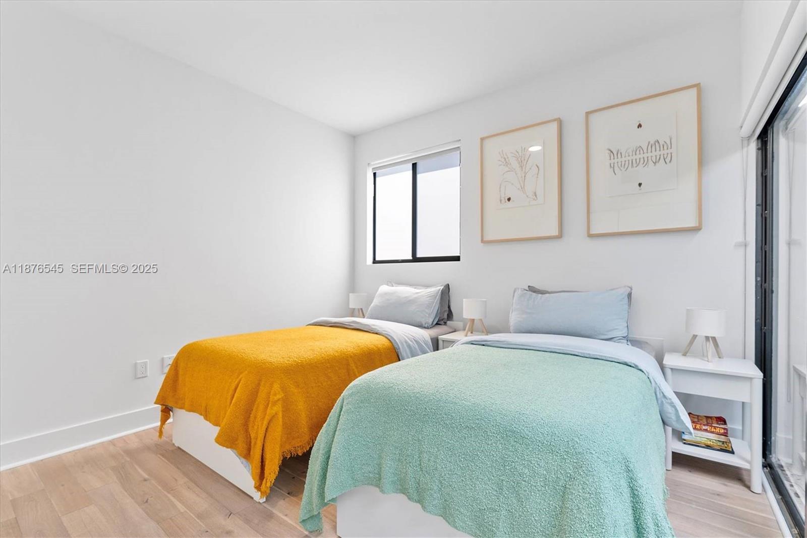 1076 Northwest 55th Street Miami, FL 33127 - Photo 36 of 96 a bedroom with two beds and painting on the wall