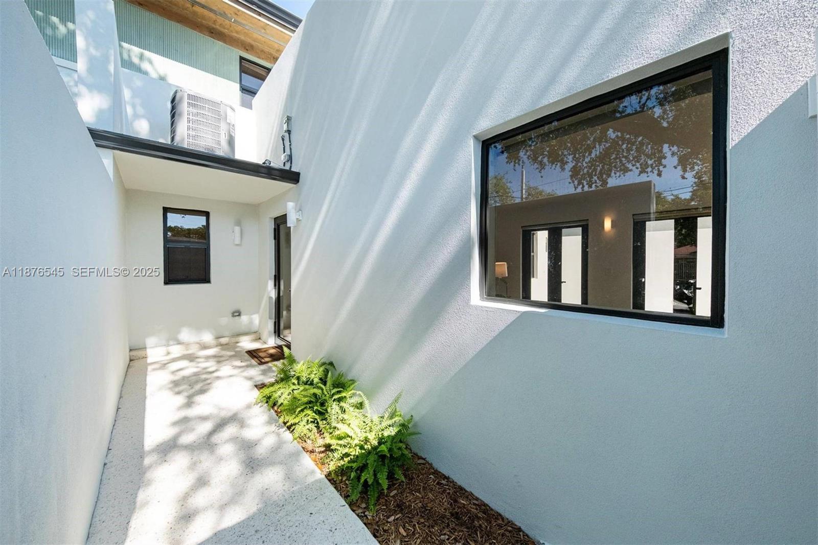 1076 Northwest 55th Street Miami, FL 33127 - Photo 57 of 96 a front view of a house with a window