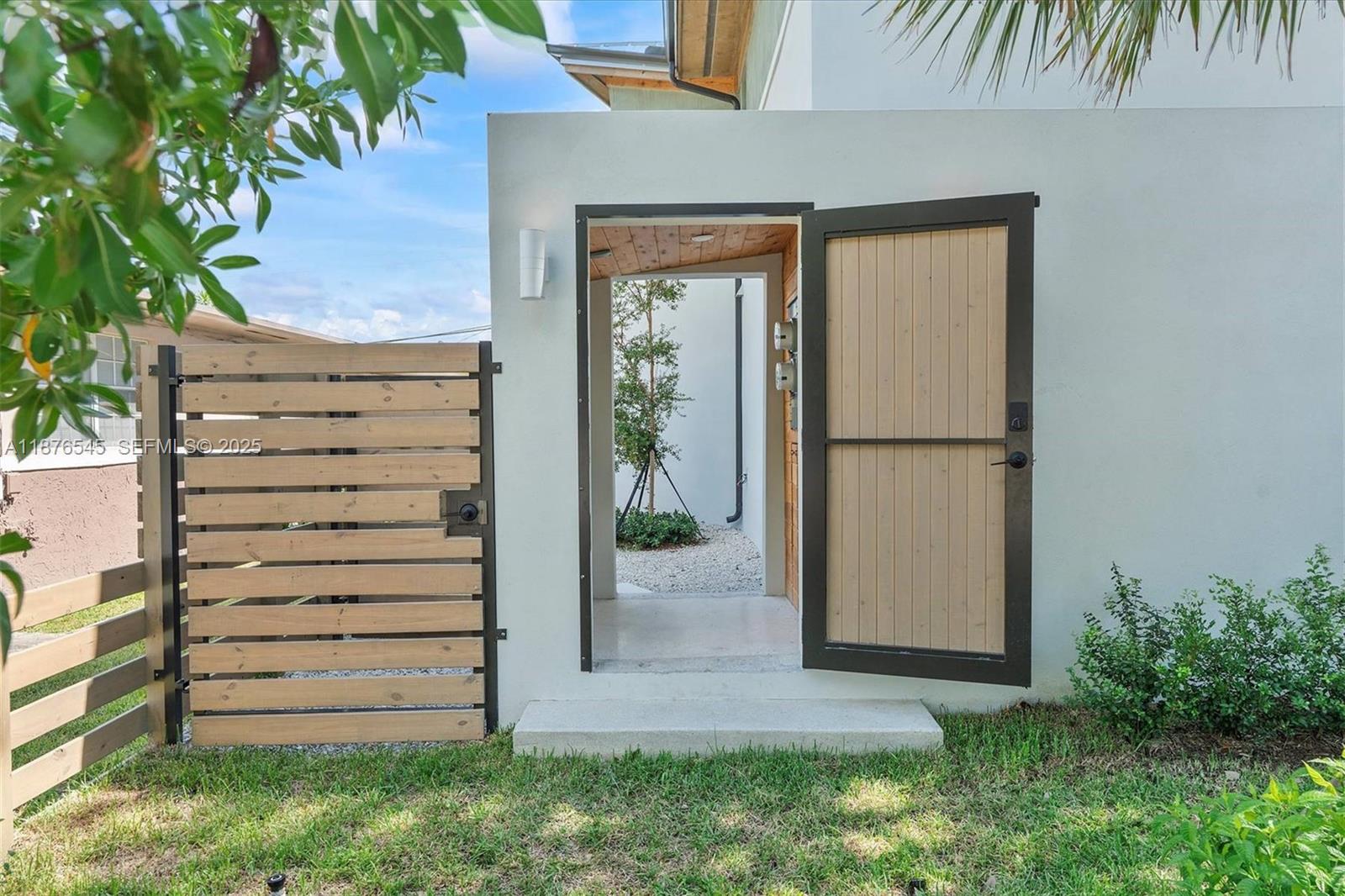 1076 Northwest 55th Street Miami, FL 33127 - Photo 6 of 96 front view of a house with a wooden fence