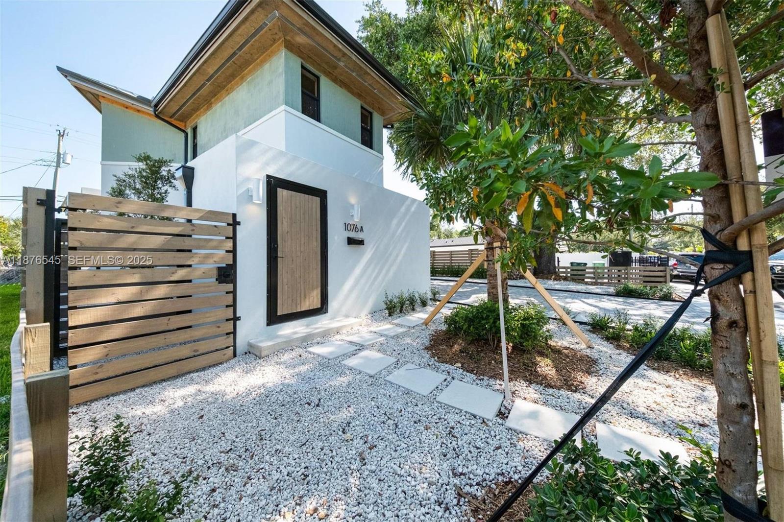 1076 Northwest 55th Street Miami, FL 33127 - Photo 62 of 96 a front view of a house with a yard