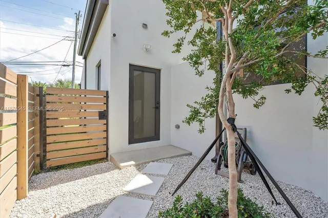 a living room with furniture and large windows