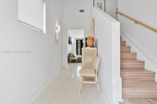 a living room with furniture and large windows