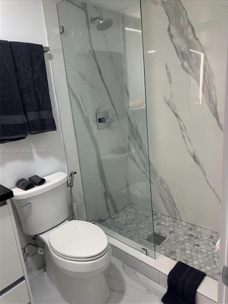 1076 Northwest 55th Street Miami, FL 33127 - Photo 86 of 96 a bathroom with a toilet and a shower