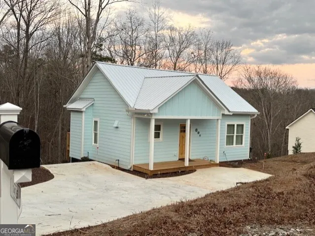 a view of a house with a yard covered in snow