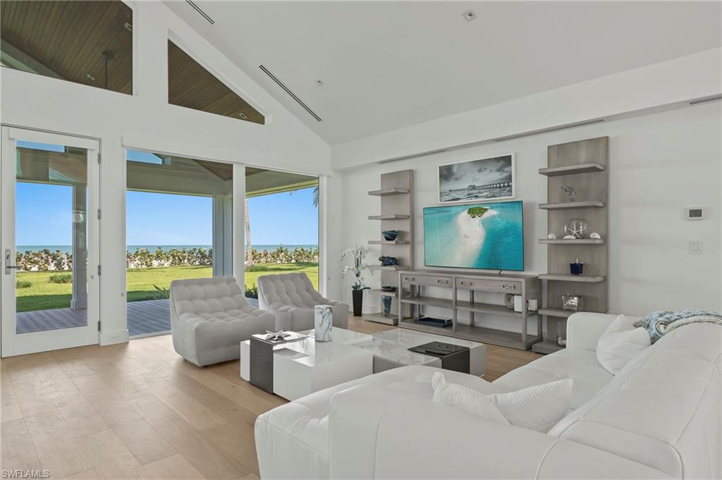 71 18th Avenue South Naples, FL 34102 - Photo 15 of 50 a living room with furniture and large windows