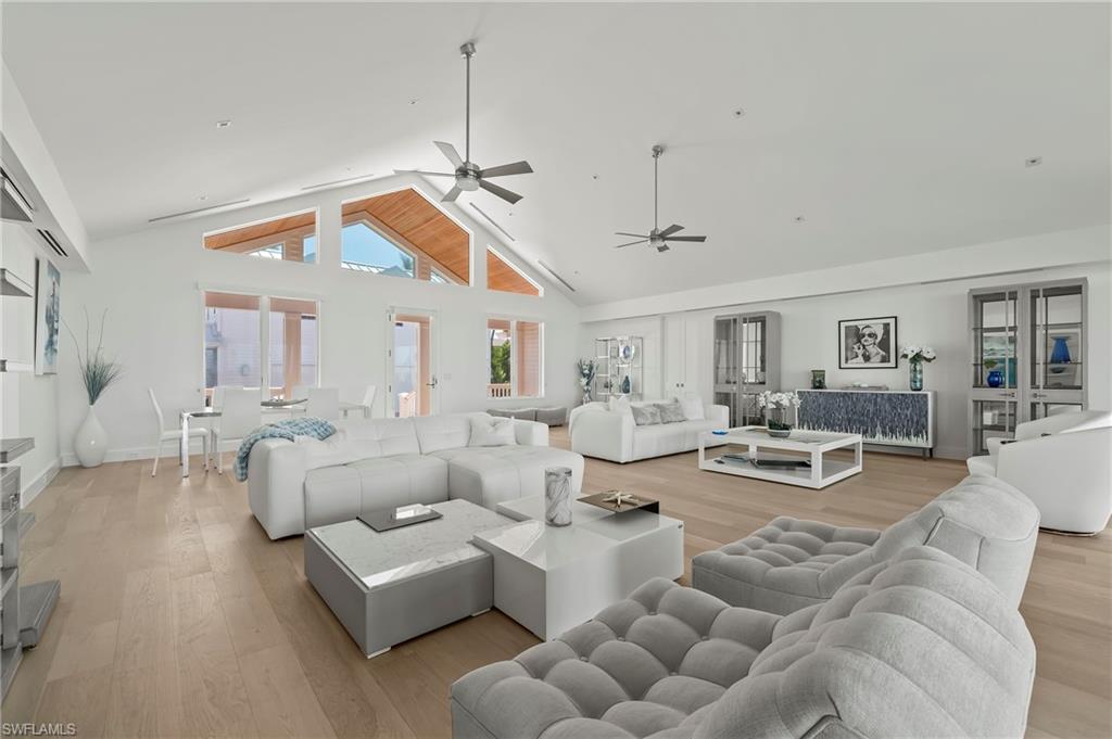 71 18th Avenue South Naples, FL 34102 - Photo 17 of 50 a living room with furniture a chandelier and a dining table