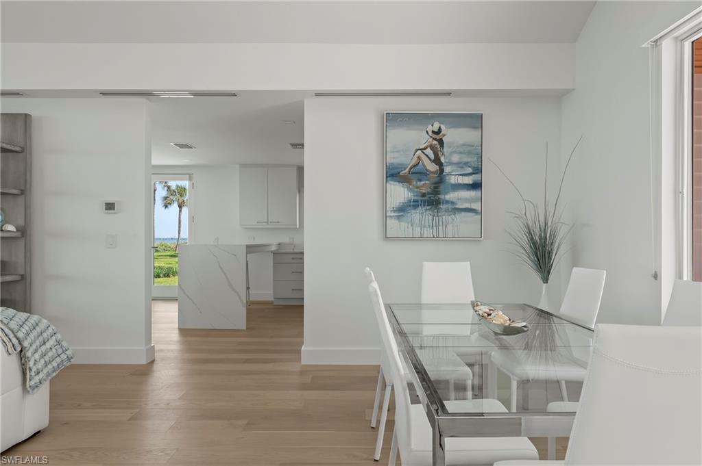 71 18th Avenue South Naples, FL 34102 - Photo 18 of 50 a view of a dining room with furniture and wooden floor