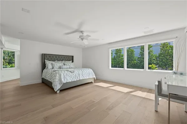 a bedroom with a large bed and a window