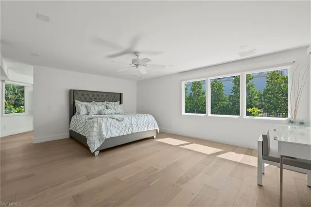 a bedroom with a large bed and a window