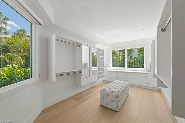 a room with a bed and a large window