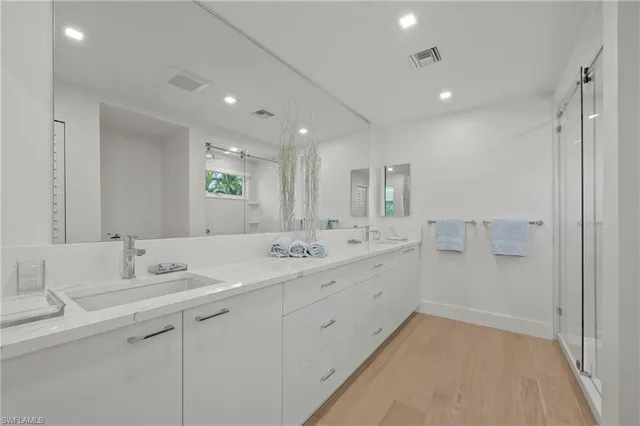 a bathroom with a granite countertop sink mirror and double