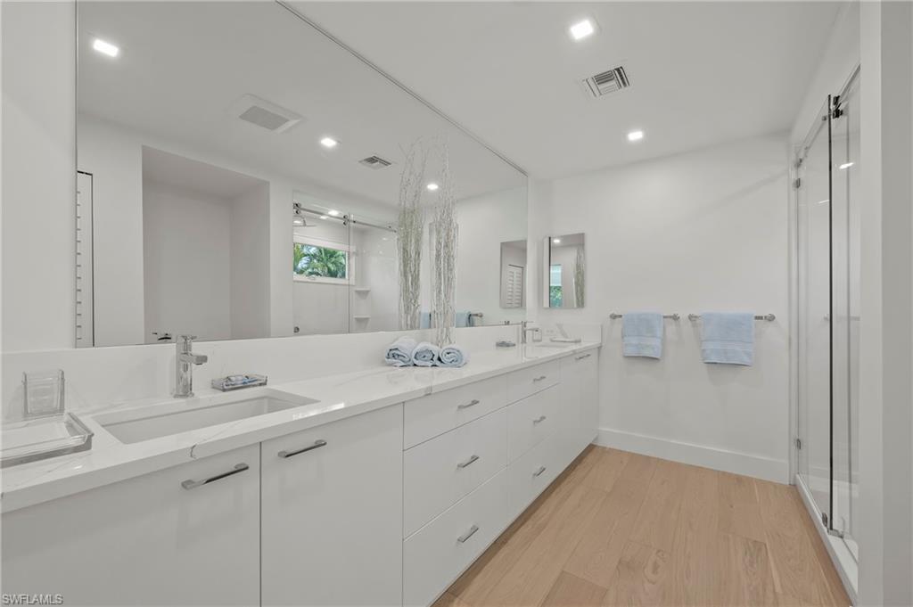 71 18th Avenue South Naples, FL 34102 - Photo 26 of 50 a bathroom with a granite countertop sink mirror and double