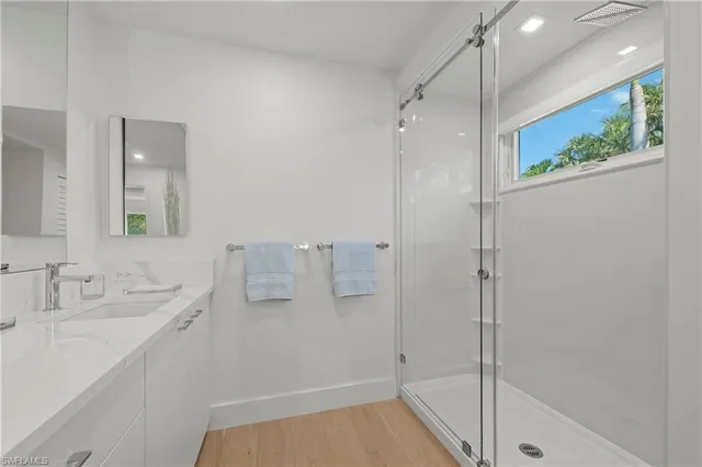 a bathroom with a shower tub and mirror