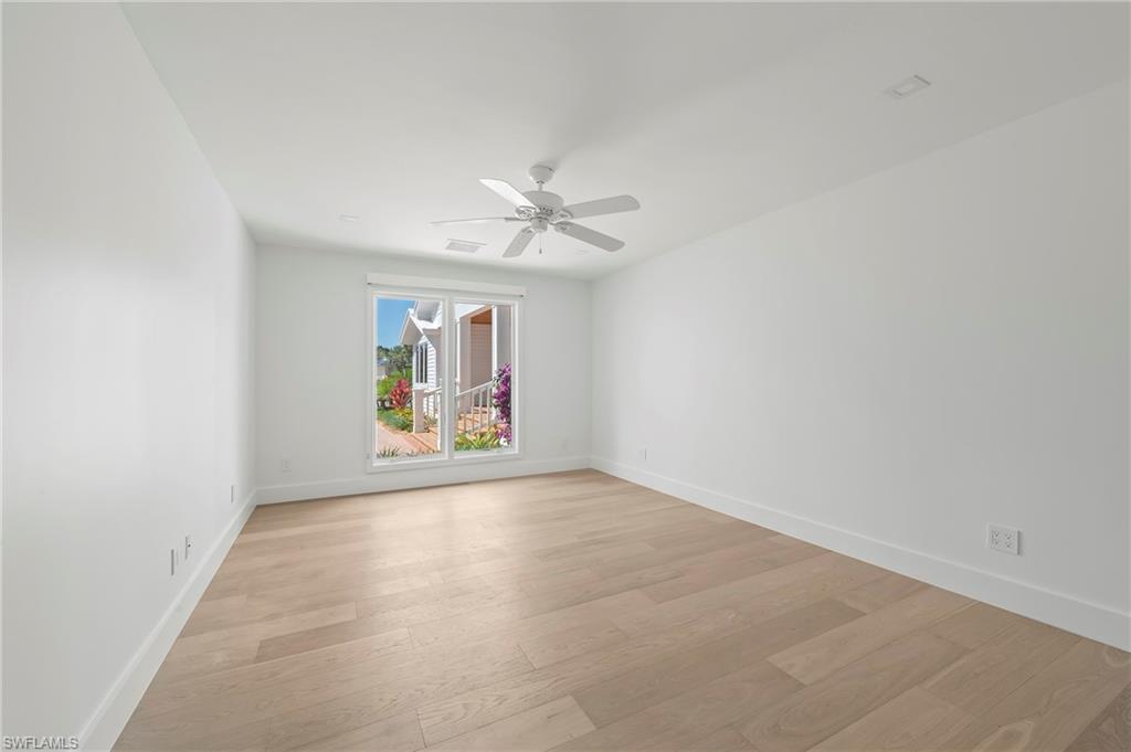 71 18th Avenue South Naples, FL 34102 - Photo 30 of 50 an empty room with fan and windows