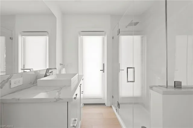 a bathroom with double vanity sink and a mirror