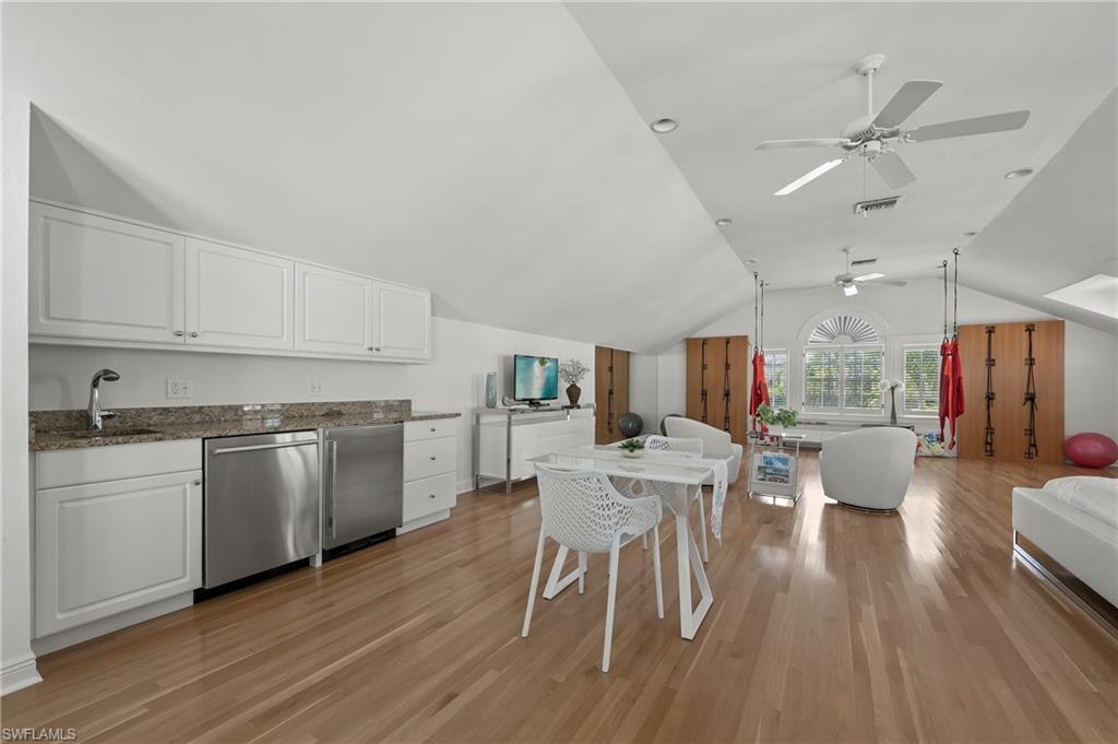 71 18th Avenue South Naples, FL 34102 - Photo 36 of 50 a kitchen with a table chairs stove and cabinets