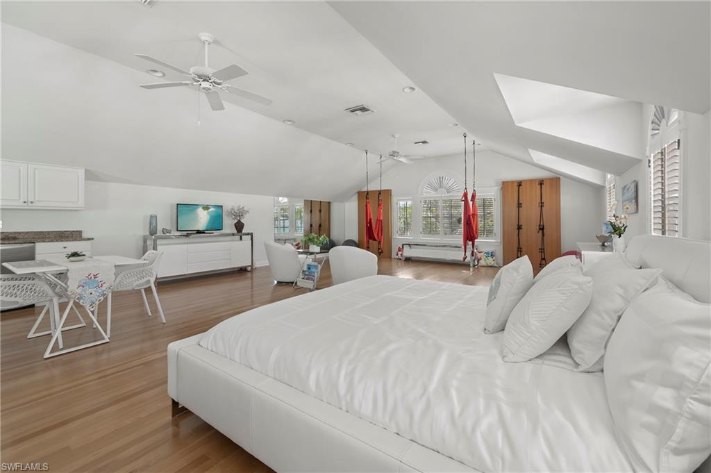 71 18th Avenue South Naples, FL 34102 - Photo 37 of 50 a bed room with a bed and a chair