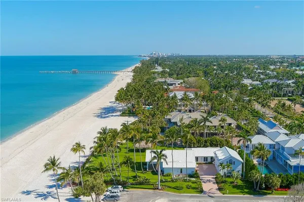 an aerial view of a house with a yard and lake view