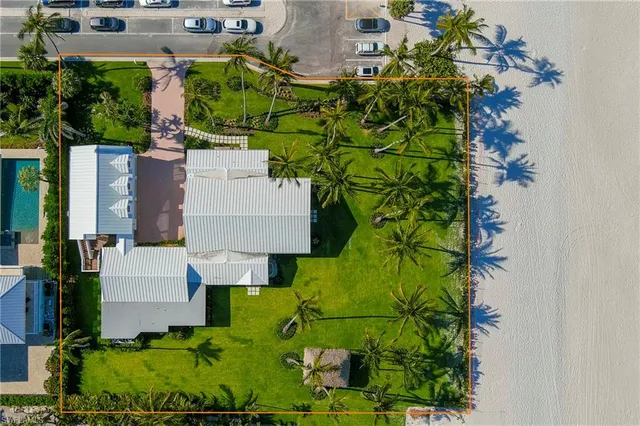 an aerial view of a house with a yard and garden