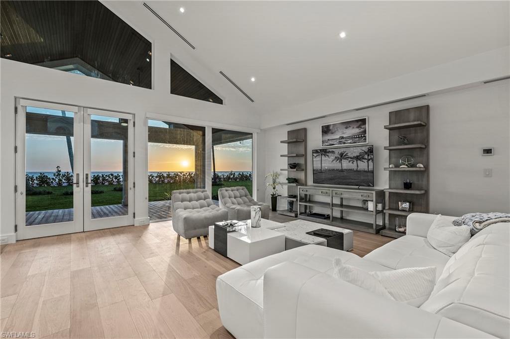 71 18th Avenue South Naples, FL 34102 - Photo 47 of 50 a living room with furniture and a floor to ceiling window