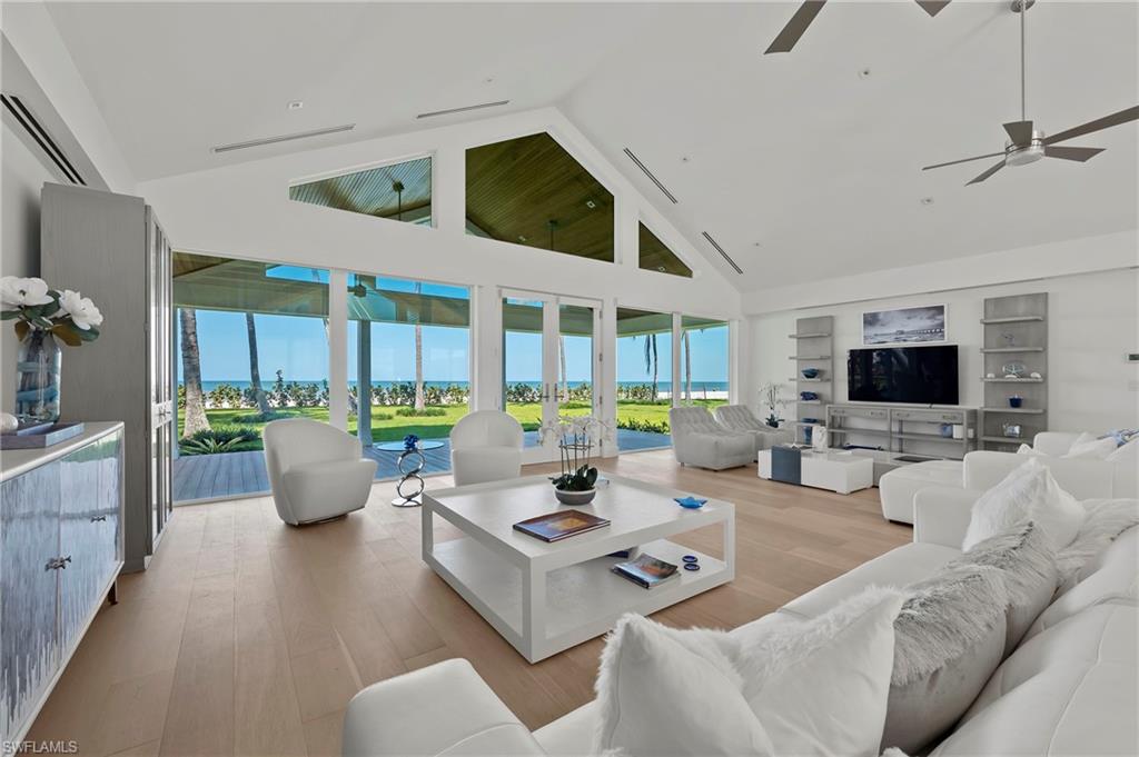 71 18th Avenue South Naples, FL 34102 - Photo 10 of 50 a living room with furniture large window and flat screen tv