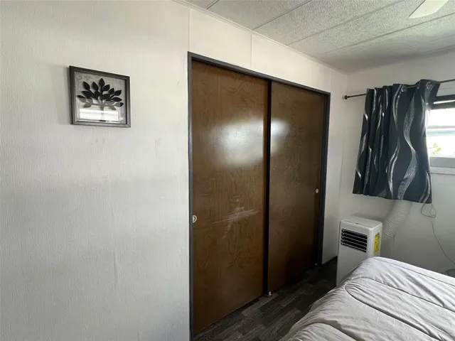 a bedroom with a bed and a view of bathroom