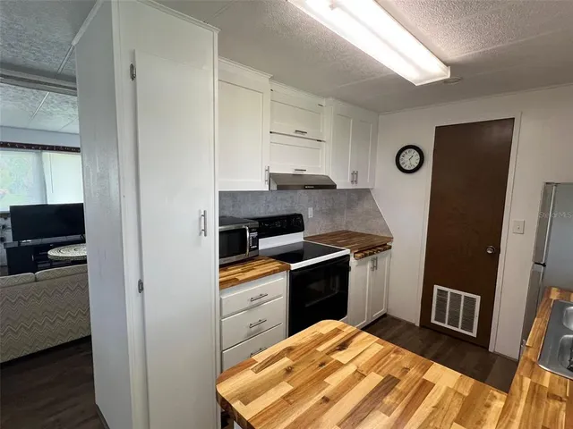 a kitchen with a sink and a stove top oven