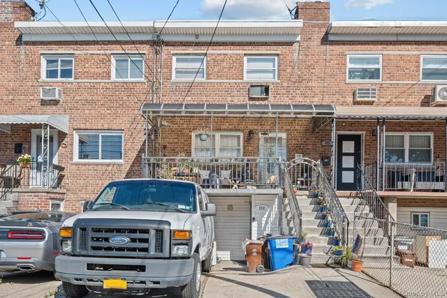 a front view of a building with parking