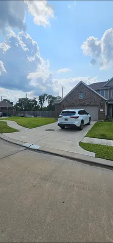 a view of yard with mountain and car parked