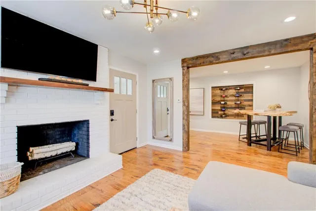 a living room with furniture a flat screen tv and a fireplace